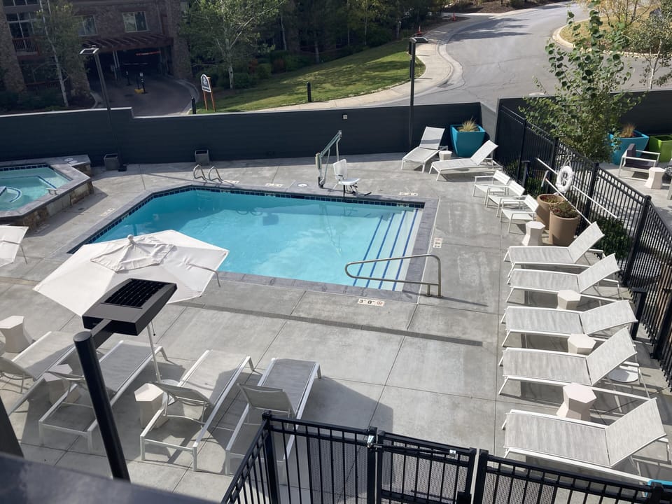 View of pool in summer looking out sliders 