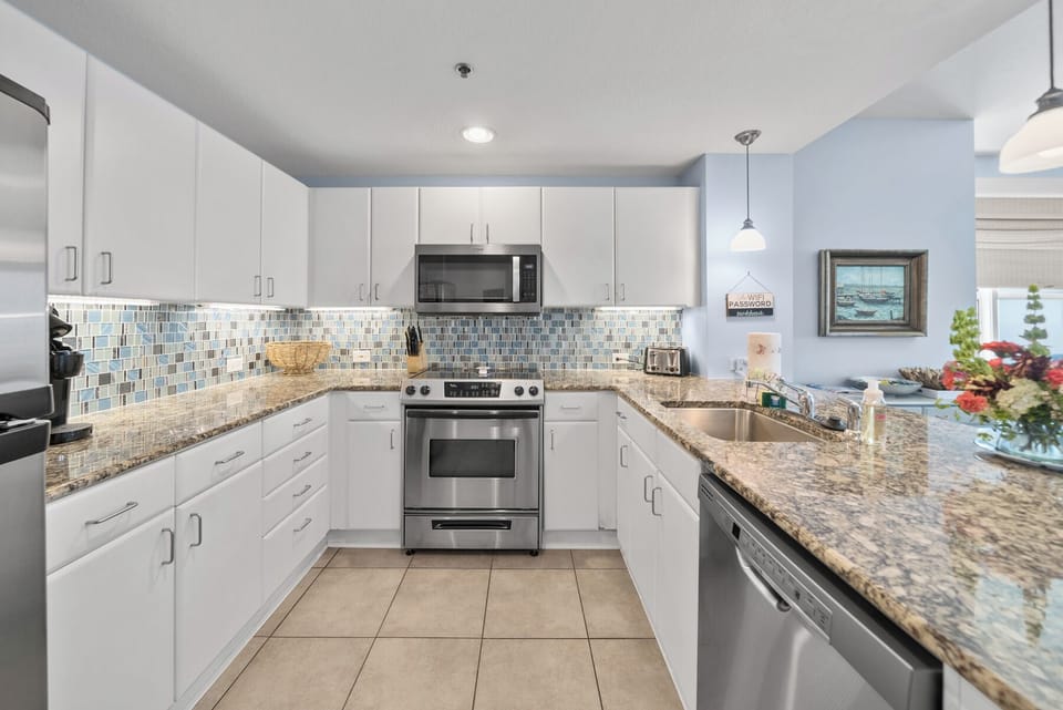 You'll love cooking in this bright, modern kitchen with granite countertops, stylish mosaic backsplash, and all the appliances you need for your stay.