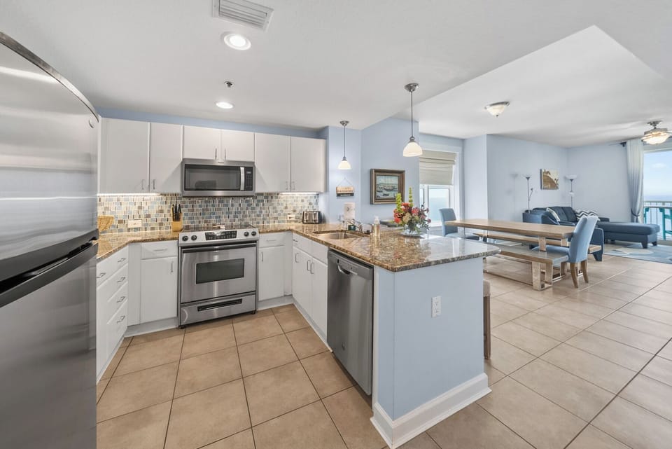 Your fully-equipped kitchen features granite countertops, stainless appliances, and opens to a comfortable living space perfect for entertaining.