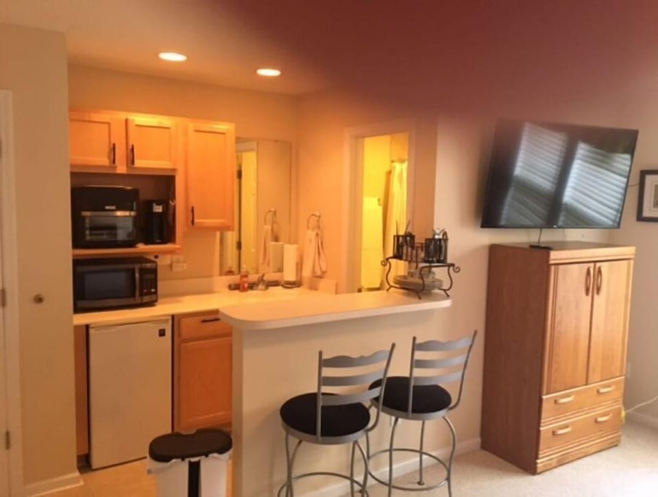 Kitchenette and dining bar. 50" TV