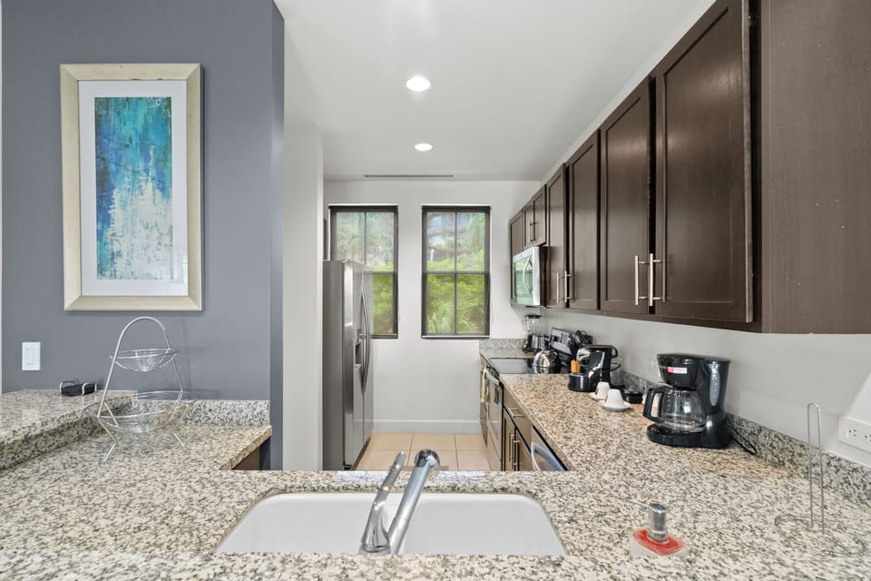 The fully equipped kitchen includes stainless steel appliances, and all the comforts of home. 