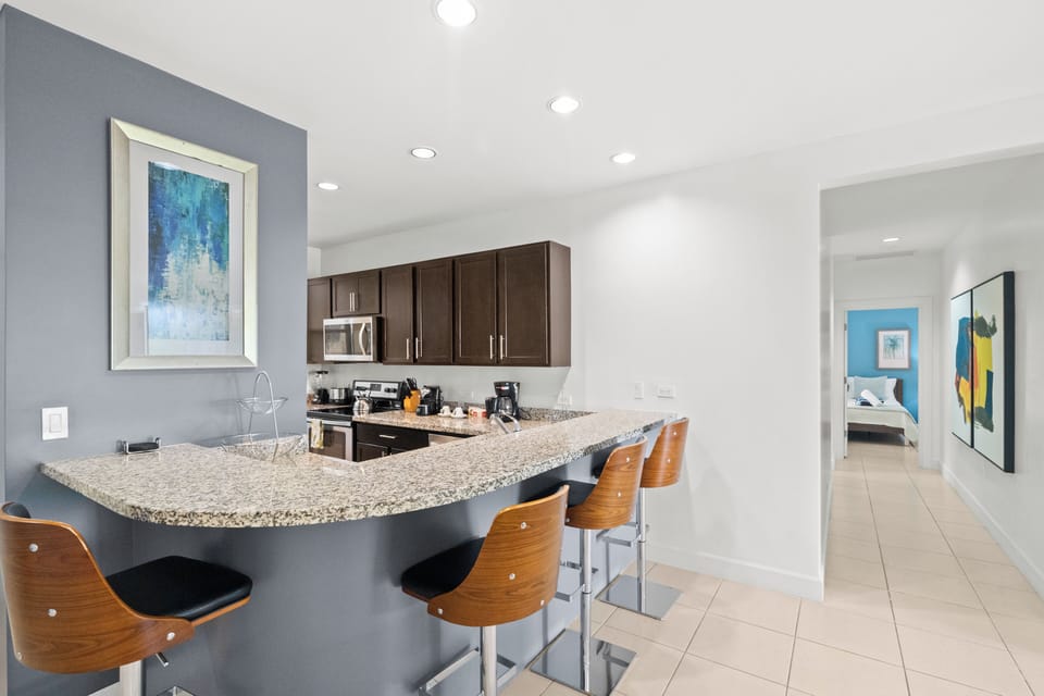 The unit has breakfast bar seating for 4, plus a 6-person dining table.  