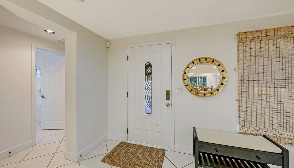 Main entrance foyer just inside the home.  To the left is the front bedroom #2.  To right, the kitchen and main living area.