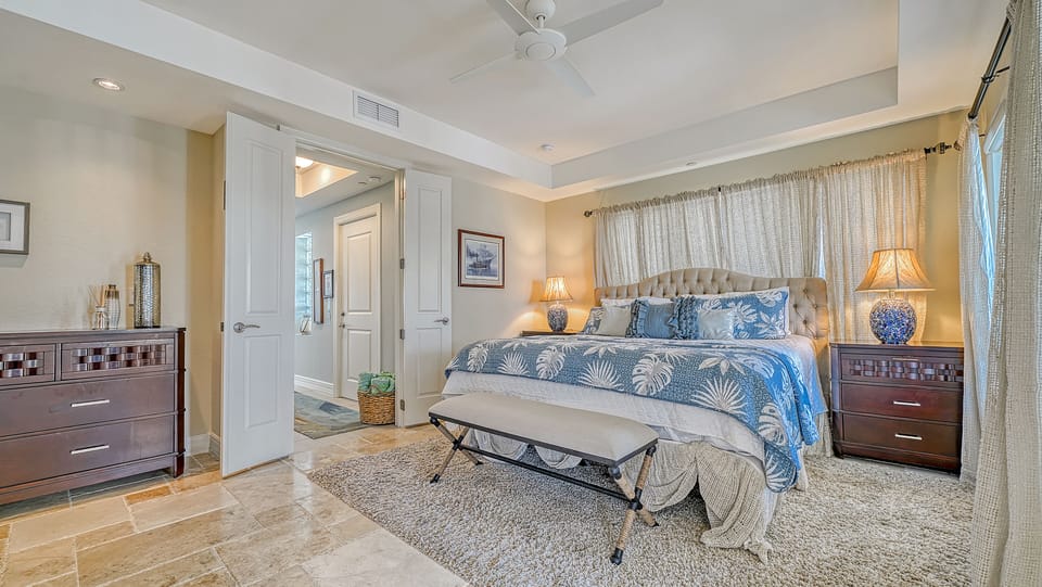 Bedroom 1, wake to soft light and a gentle breeze—this serene king suite includes balcony access and luxury finishes.