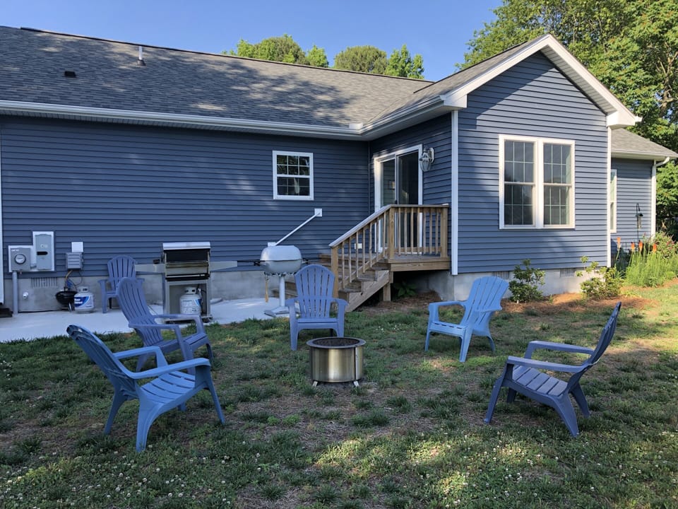 Breeo firepit and backyard ready for cornhole or wiffle ball.