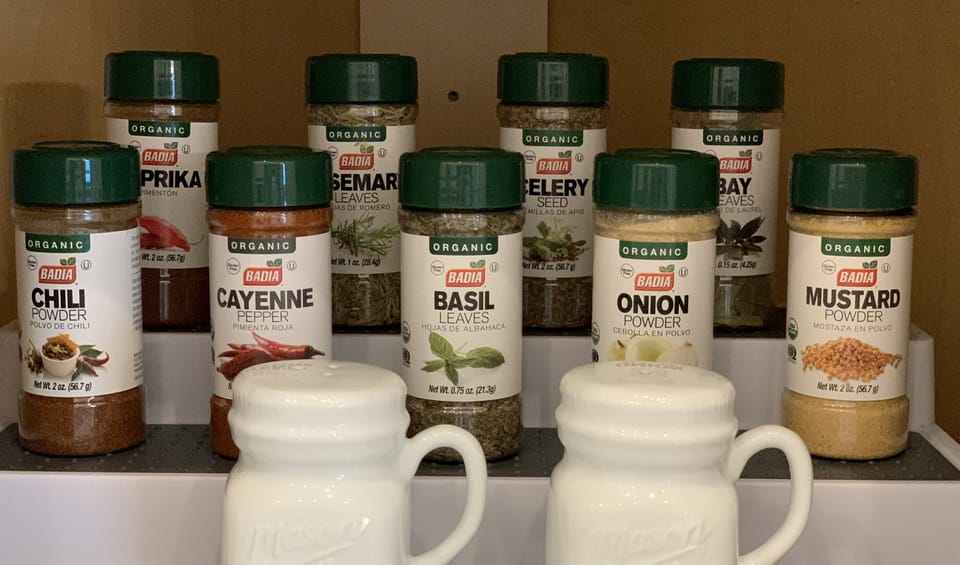 Kitchen has spices, sugar, creamers, ground coffee, Keurig coffee pods, tea, Brita water filter pitcher.