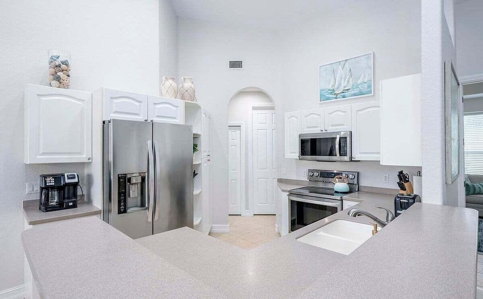 Open Kitchen with Stainless Appliances and Bar