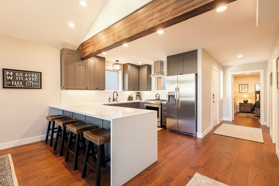 Fully Equipped Kitchen, stainless steel KitchenAid appliances, and bar seating for four