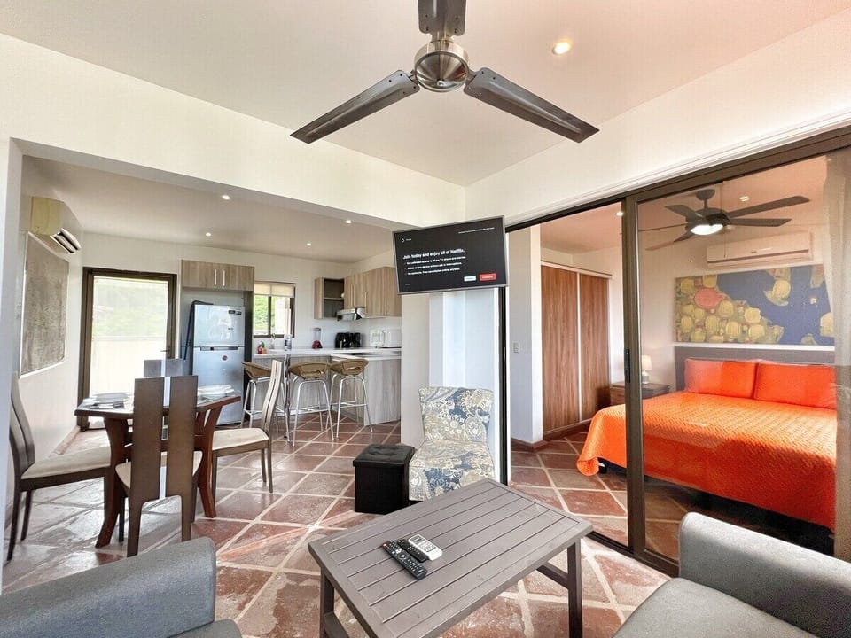 Open kitchen, dining and living space.  The door to the bedroom closes and curtains close to provide privacy from the living space.  