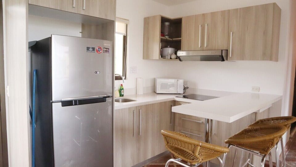 Equipped kitchen with fridge, microwave and ceramic cooktop.  An air fryer has been added as well!