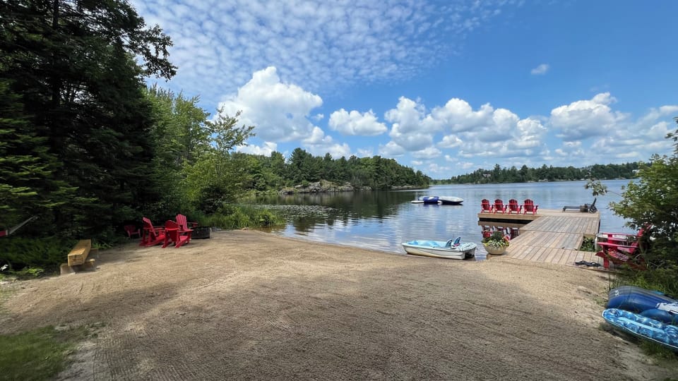 Shallow sandy beach with a deep drop off at the dock for diving.
