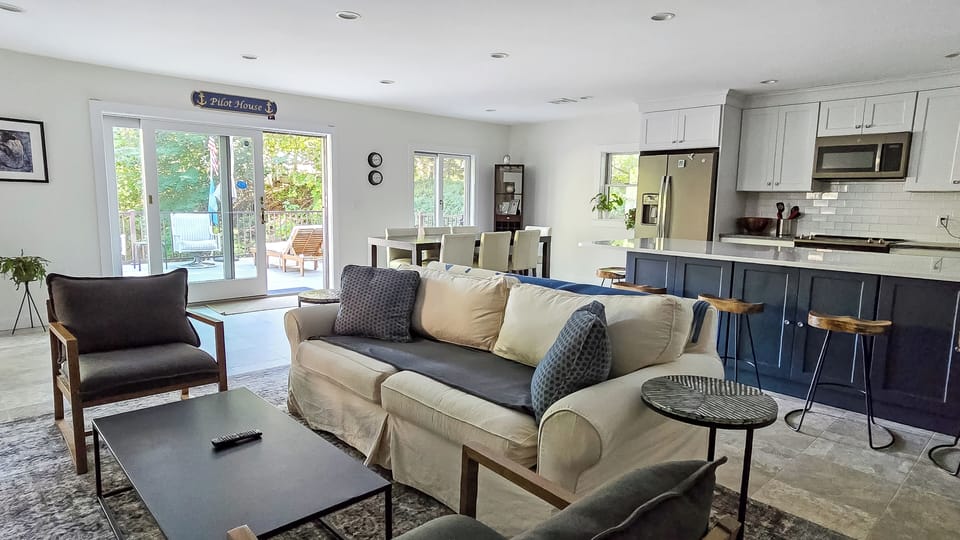 Living room opens to dining area and kitchen beyond
