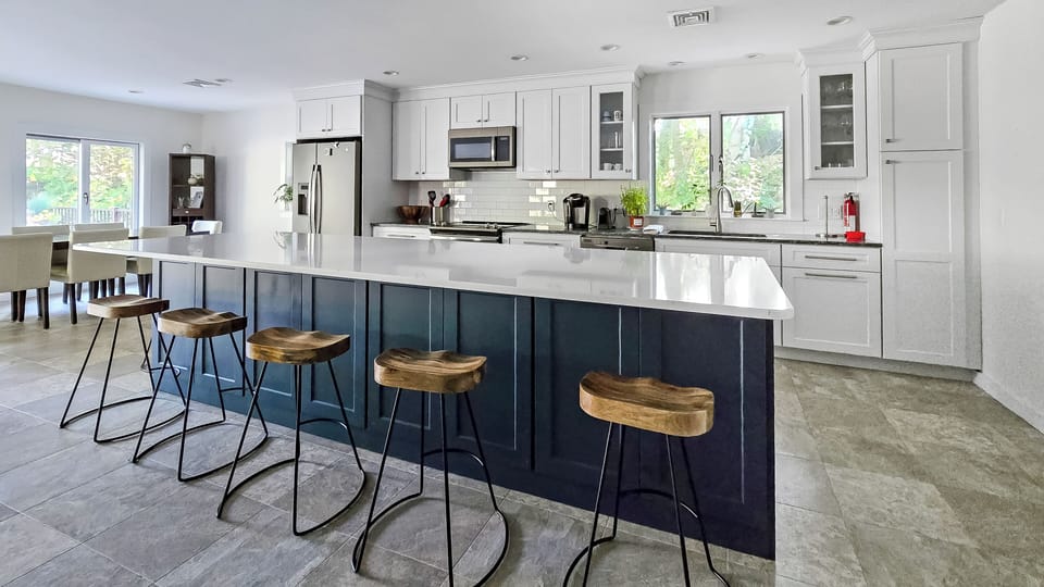 Nicely equipped kitchen with large center island and counter seating