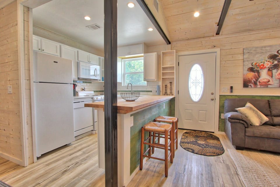 View from bedroom showing the entry door and kitchen.