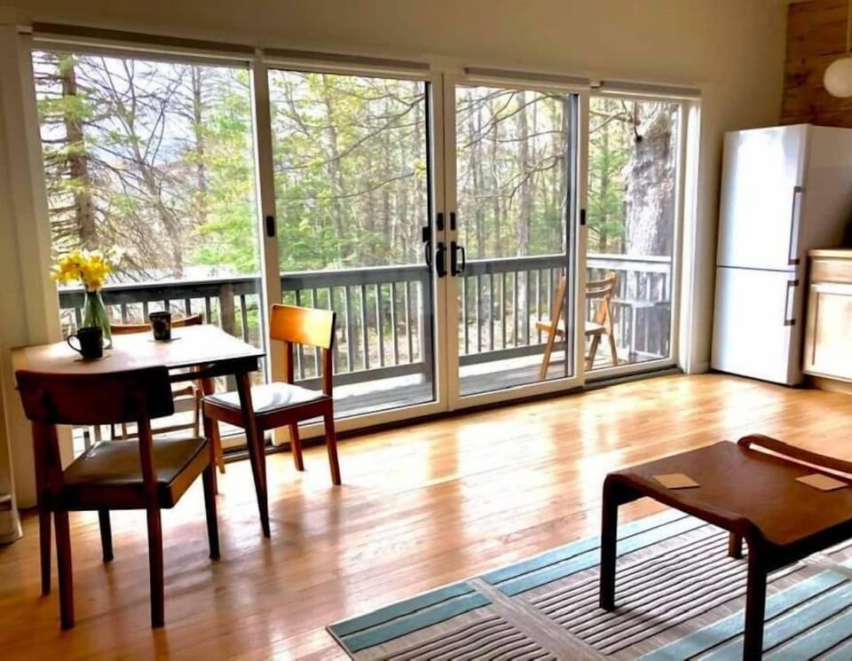 An expanse of sliding glass doors leads to the balcony, with mountain views.