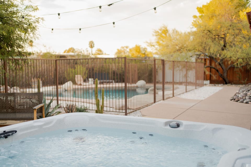 New 7 person hot tub under bistro lights in the fenced back yard. Super private!