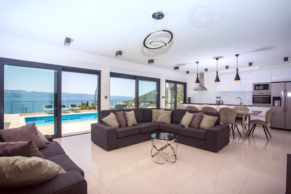 ground floor offers a spacious living room with floor-to-ceiling sliding glass