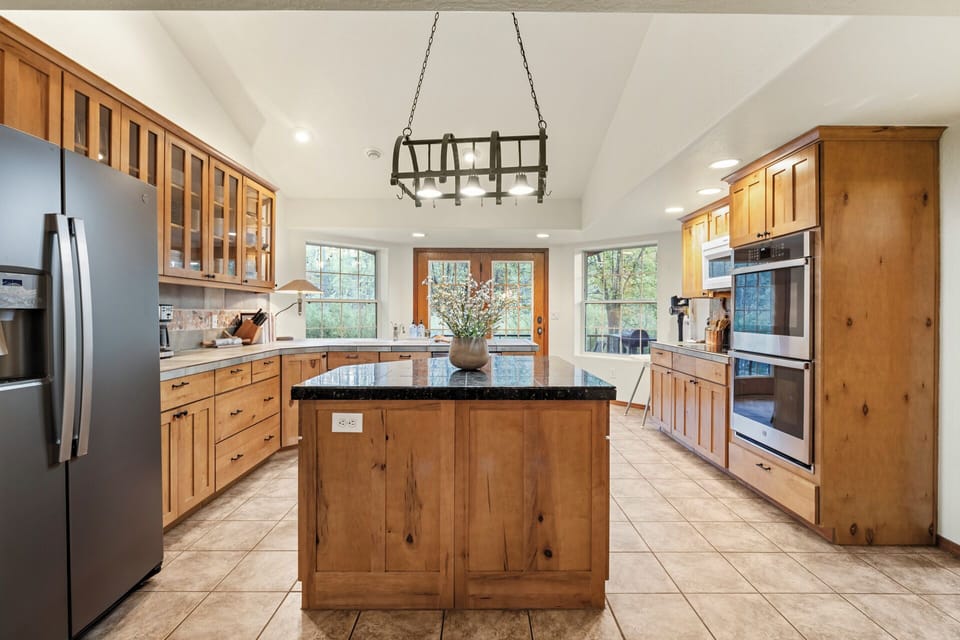 Large kitchen w/ panoramic views leads out to deck