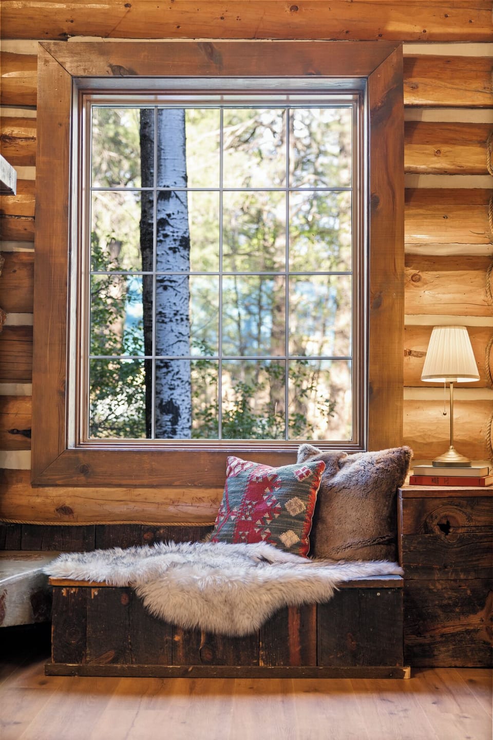 Cozy reading nook in the living room looks out into the aspen forest
