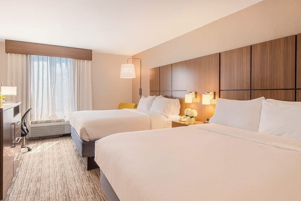Settle into sunlit comfort with two plush queen beds.