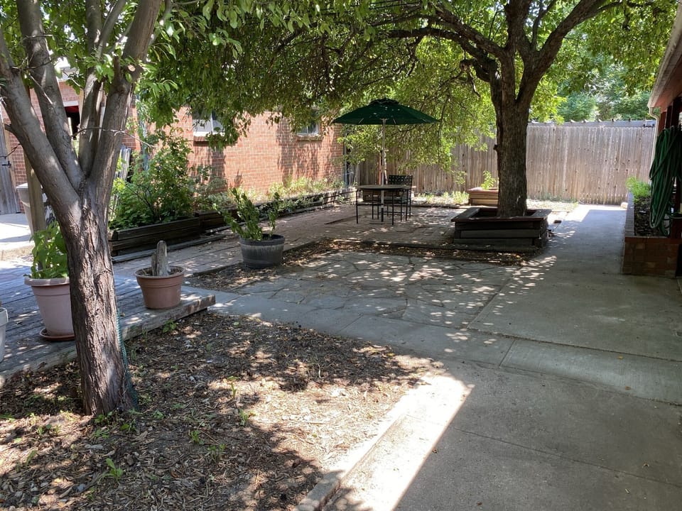 The back courtyard also has a table.
