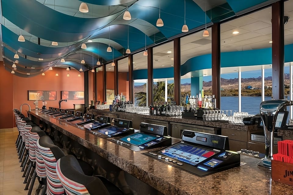 Gather at the sleek bar with sparkling water views.