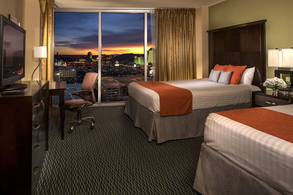 Soak in the skyline views from your serene bedroom retreat