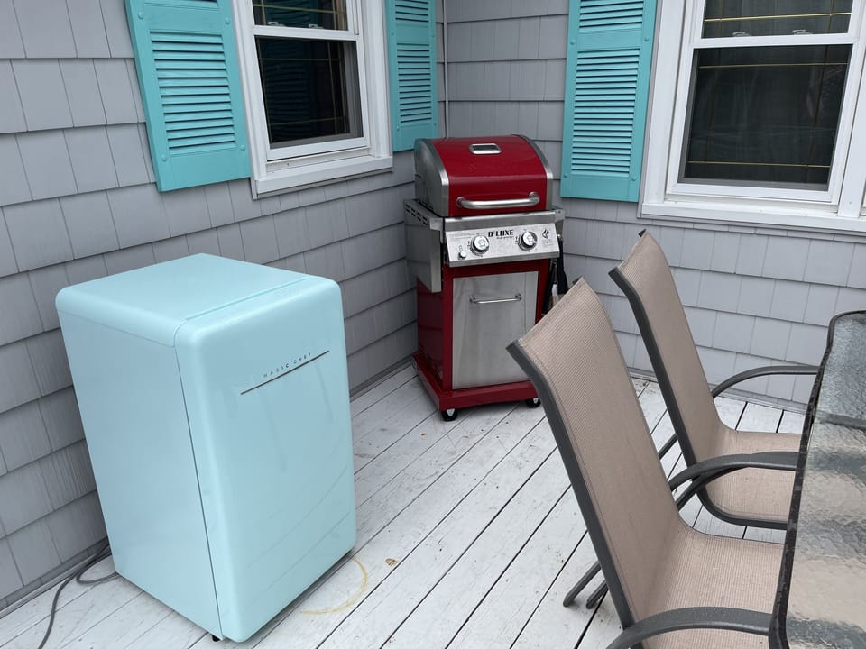 Side porch with gas grill, small fridge and dining for 6