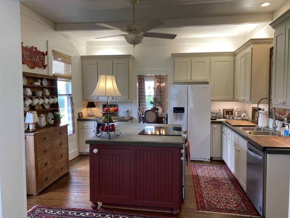 Enormous cooks kitchen viewed from the in-kitchen sitting area. 