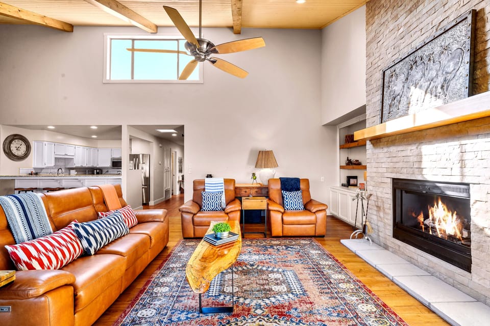 Another view of the living area with a cozy fireplace.