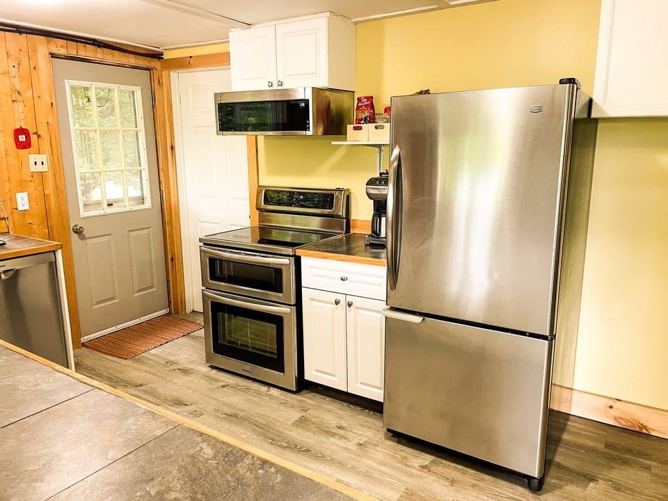 Stainless steel appliances adorn the kitchen
