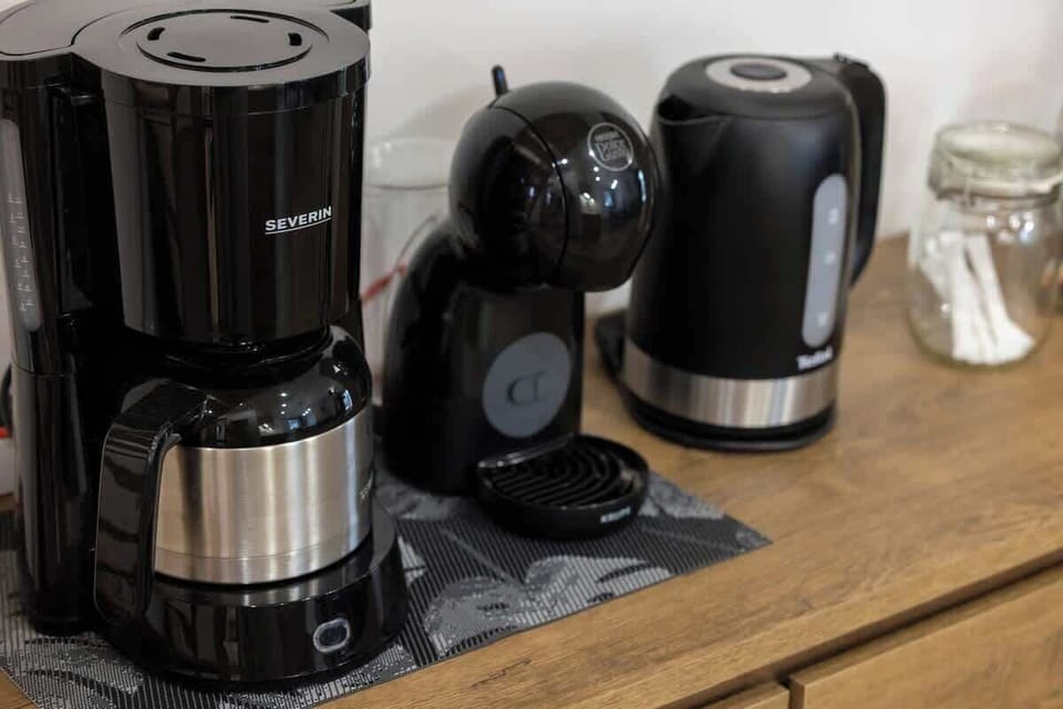 Fully equipped kitchenette with electric kettle and coffee maker.