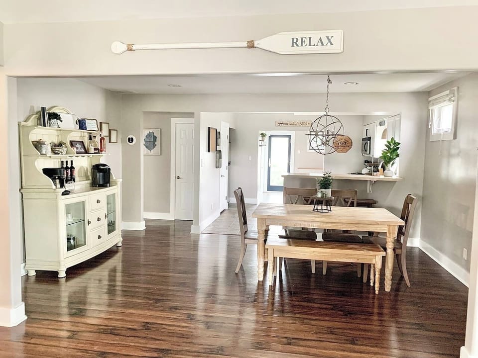Gather for a meal or a morning coffee in this bright, open dining area. The space features a rustic wooden table with bench seating, a stylish bar area, and a dedicated coffee station to kickstart your vacation mornings.