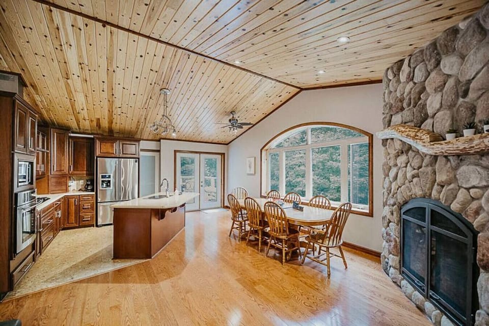 Large open space kitchen and dining with views of nothing but trees. INSTAGRAM: @hiddenhideoutsWEBSITE: www.hiddenhideouts.ca