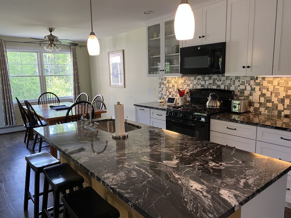 Dining area off kitchen overlooking the brook