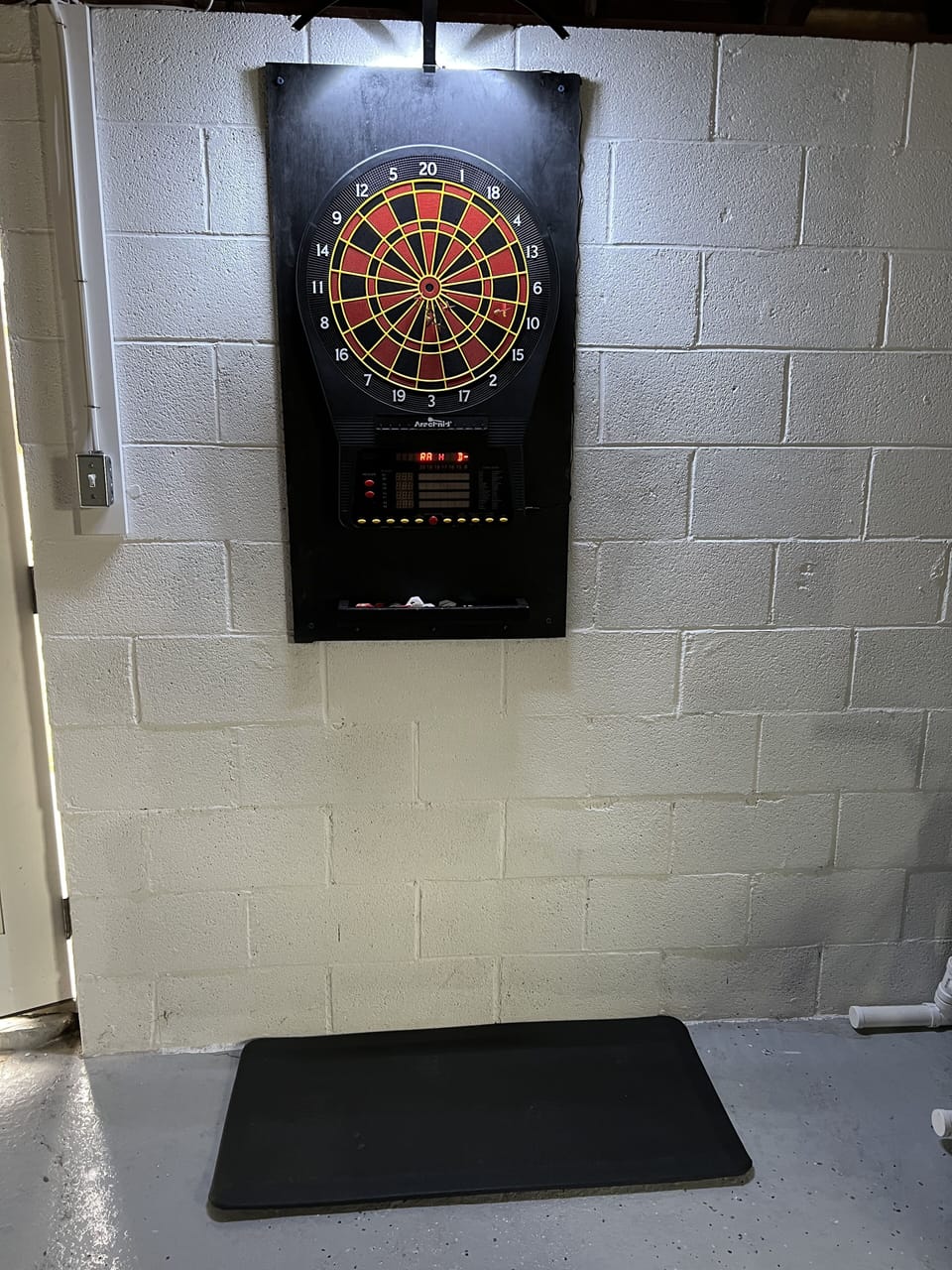 Arachnid electronic dartboard in the garage for a little competitive fun!!!