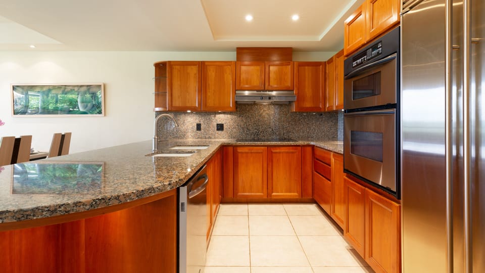 Gourmet kitchen stocked with spices, oils and cookware and essentials