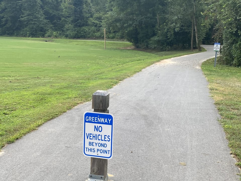 Entrance to Cary Greenway on back side of property 