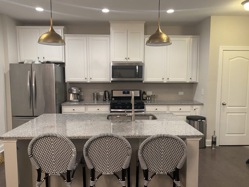 Open kitchen with bar and seating 