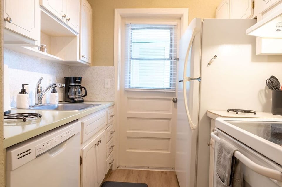Galley kitchen includes full size fridge, oven, dishwasher, & microwave