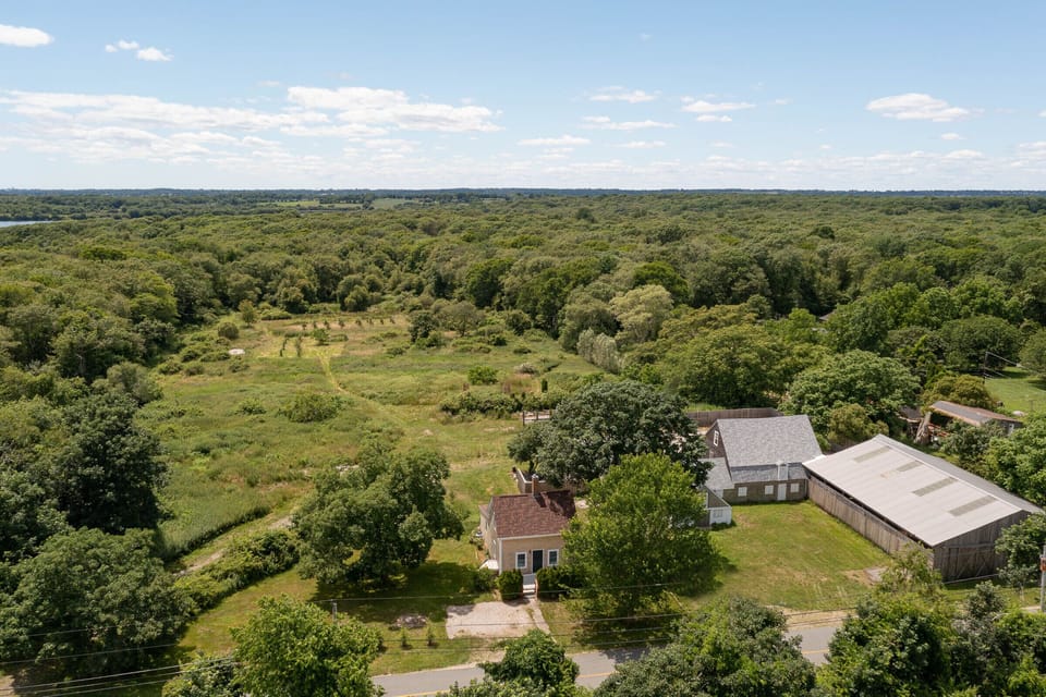 Aerial view showing home and adjacent barns