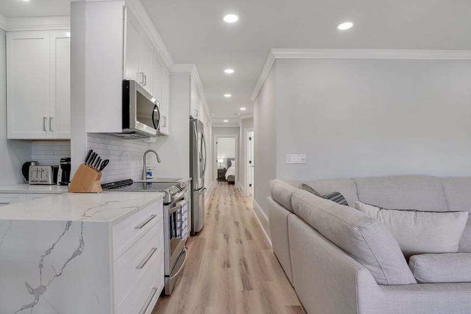 Living room, dining table and kitchen. (view 2)