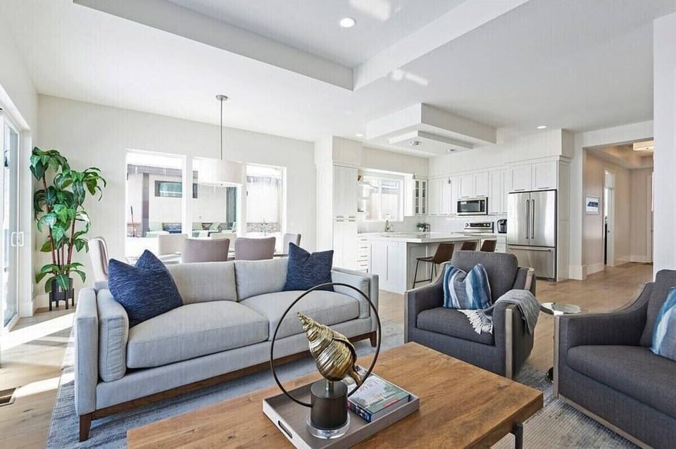 The open-concept living space, complete with a dining area, facilitates effortless conversation with family and friends.