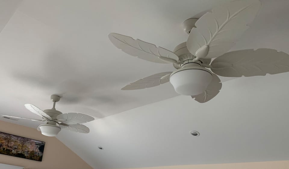 Double Bahama style ceiling fans bring the cool bay breezes indoors.