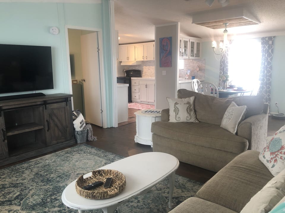 Living room with smart TV and sound bar for surround sound movies.