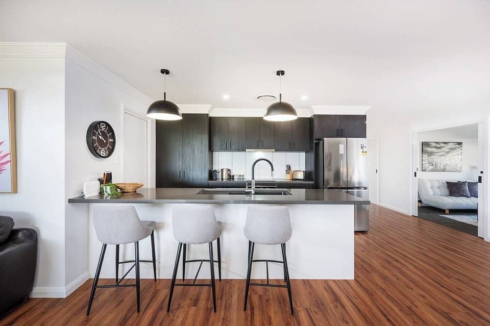 The modern, streamlined kitchen includes all the essentials needed to cook up a feast at home.
