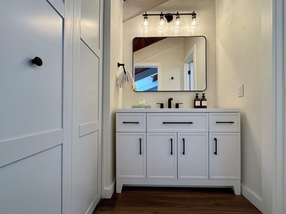 Loft bathroom has closet and separate vanity.