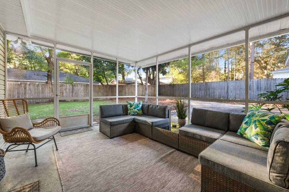 Large screened porch with ample seating and fully fenced backyard