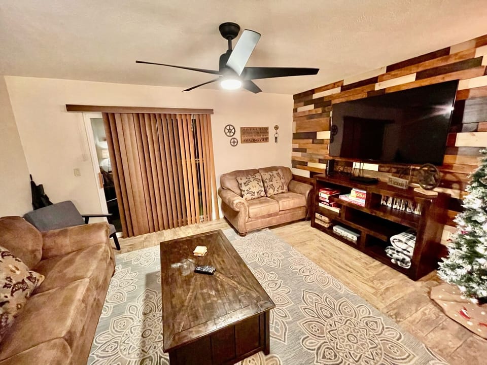 Family room w/ sleeper sofa and loveseat and 55" Smart TV in unit 4