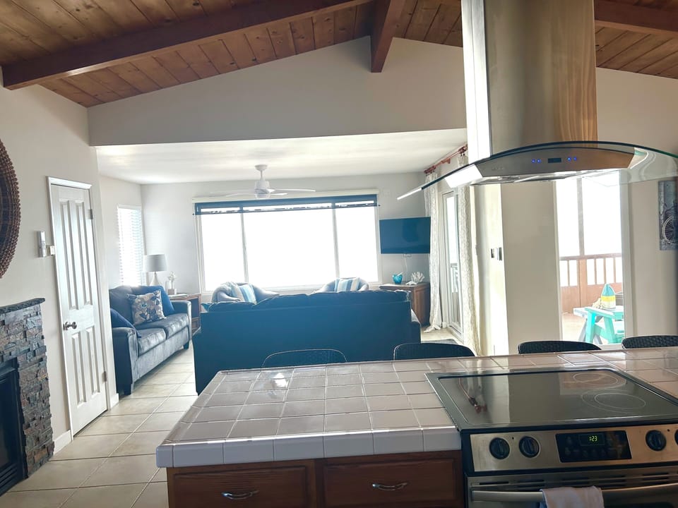 View from Kitchen into Living Room. Bar Seating at Kitchen Counter.
